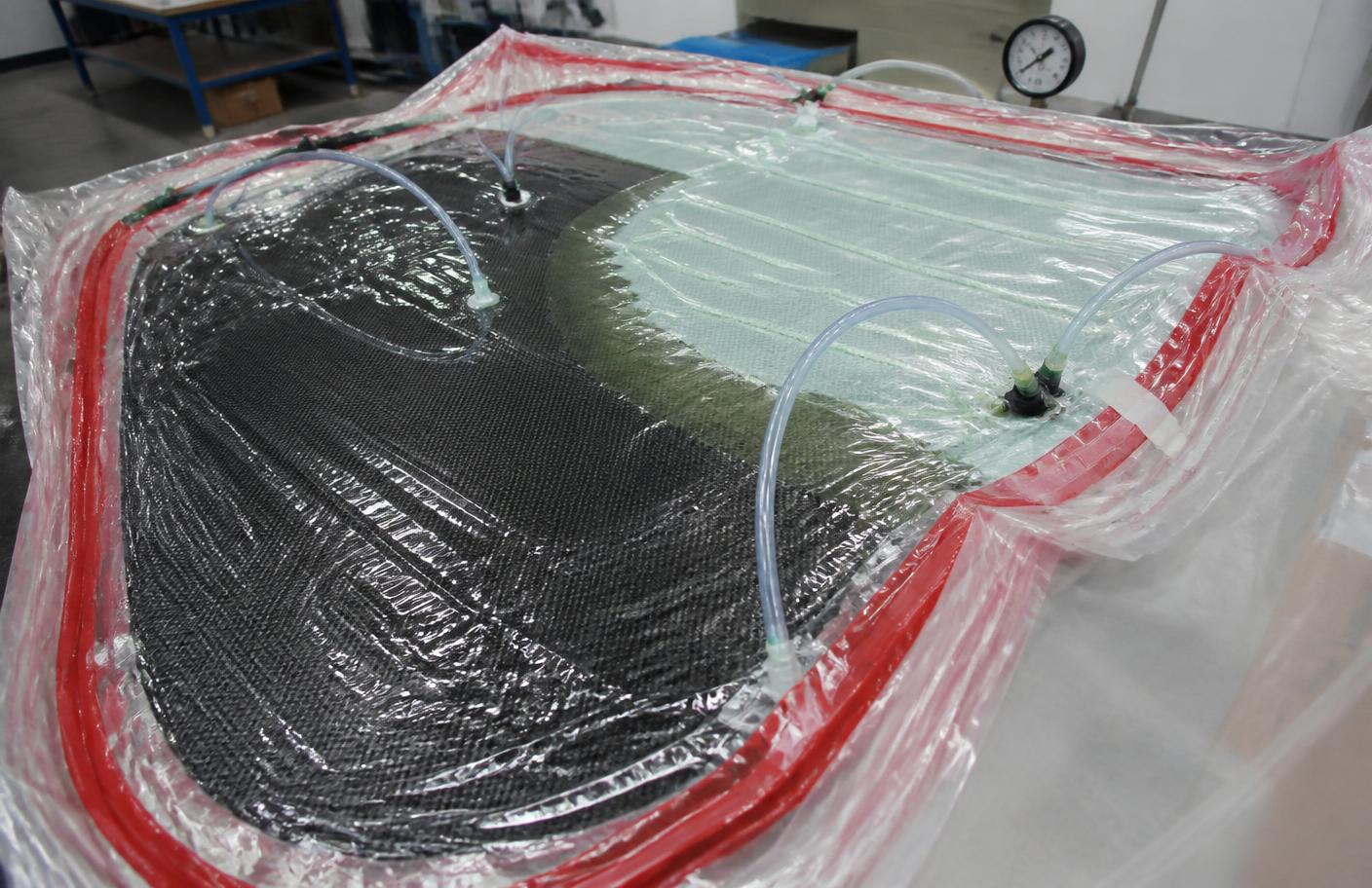 Composite part sealed under vacuum bagging film during resin infusion
